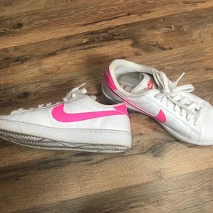 Womens white and hot pink Nike court sneakers.